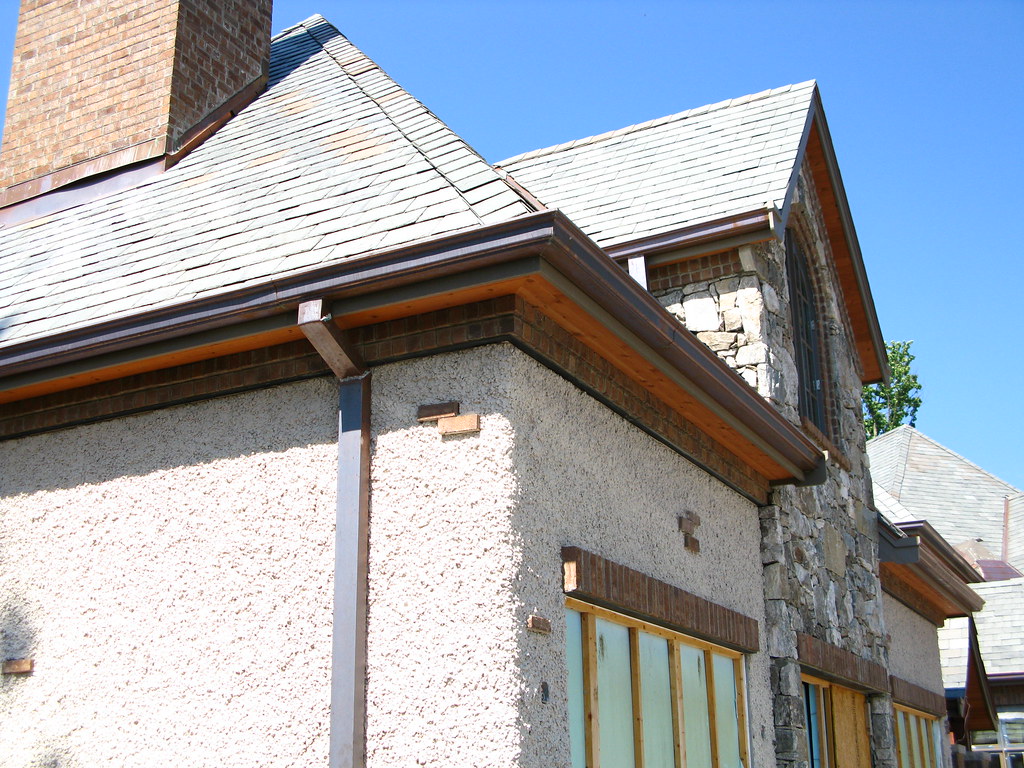 Roof gutter and downpipe on a tiled home
